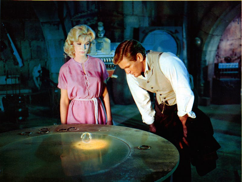 Yvette Mimieux and Rod Taylor stare at a mysterious orb in a scene from the film 'The Time Machine',...