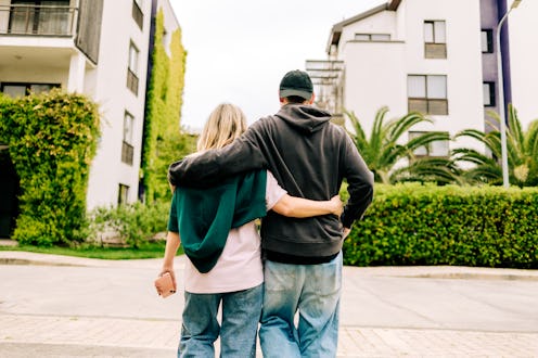 Couple embracing and looking at new home