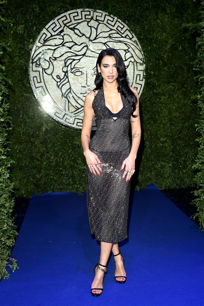 MILAN, ITALY - SEPTEMBER 26: Dua Lipa is seen on the front row of the Versace special event during t...