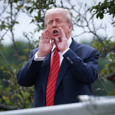 WASHINGTON, DC - AUGUST 05: U.S. President Donald Trump shouts answers to questions from reporters as he tours the roof of the West Wing of the White House on August 05, 2025 in Washington, DC. Trump has undertaken several renovation projects at the White House to include the construction of a concrete patio at the Rose Garden. (Photo by Win McNamee/Getty Images)