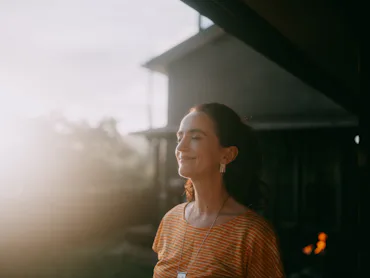 Woman having eyes closed and relaxing at sunset, Japan