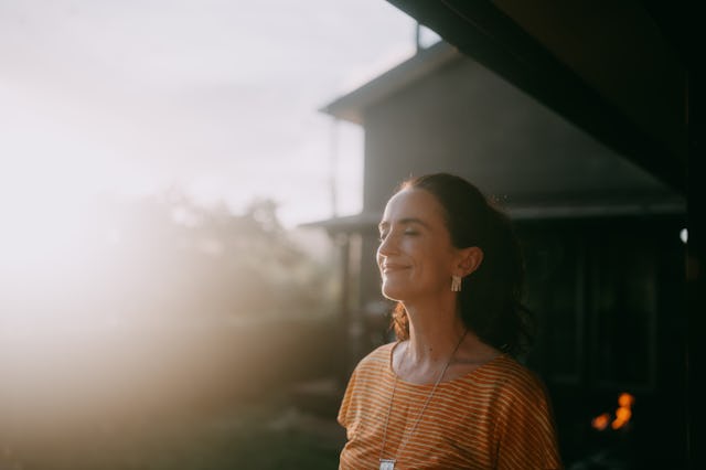 Woman having eyes closed and relaxing at sunset, Japan