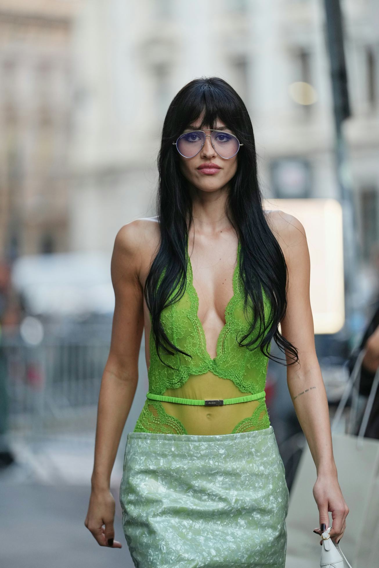 MILAN, ITALY - SEPTEMBER 23: Amelia Gray wears long straight black hair with bangs, oversized aviato...