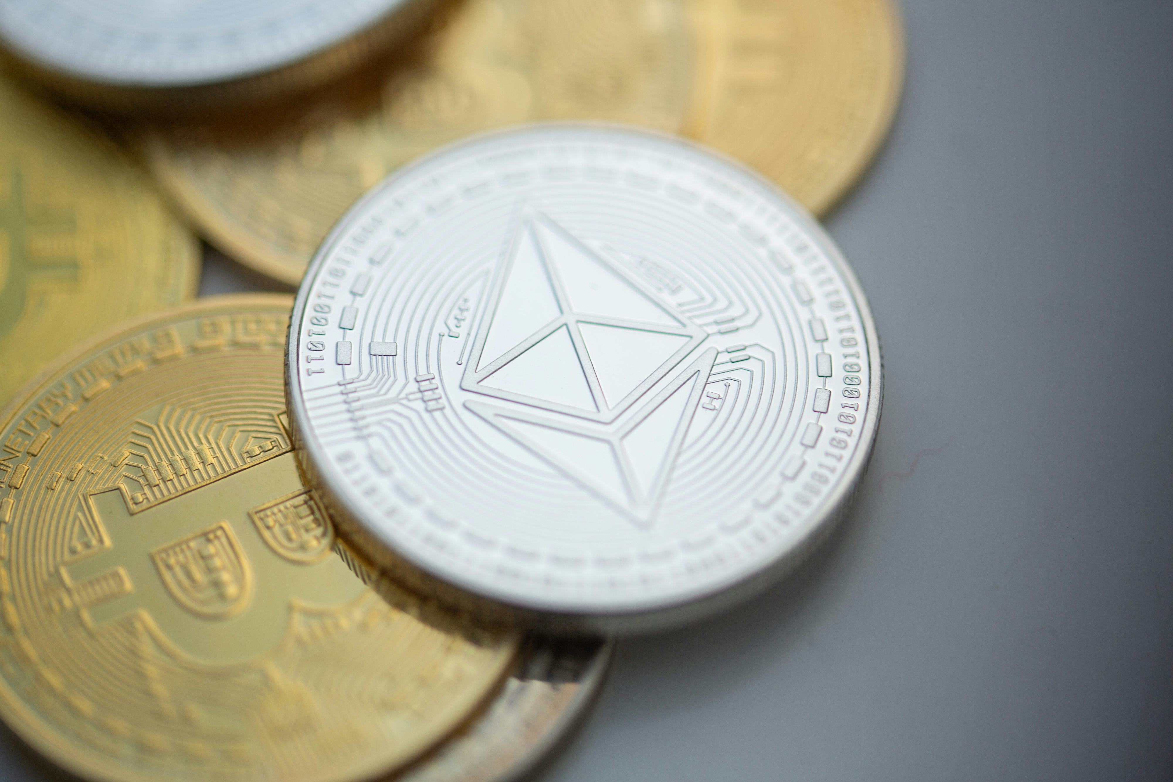 ILLUSTRATION - 10 November 2023, Berlin: An Ethereum coin lies on top of Bitcoin coins. Photo: Ferna...
