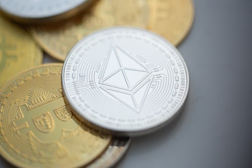 ILLUSTRATION - 10 November 2023, Berlin: An Ethereum coin lies on top of Bitcoin coins. Photo: Ferna...