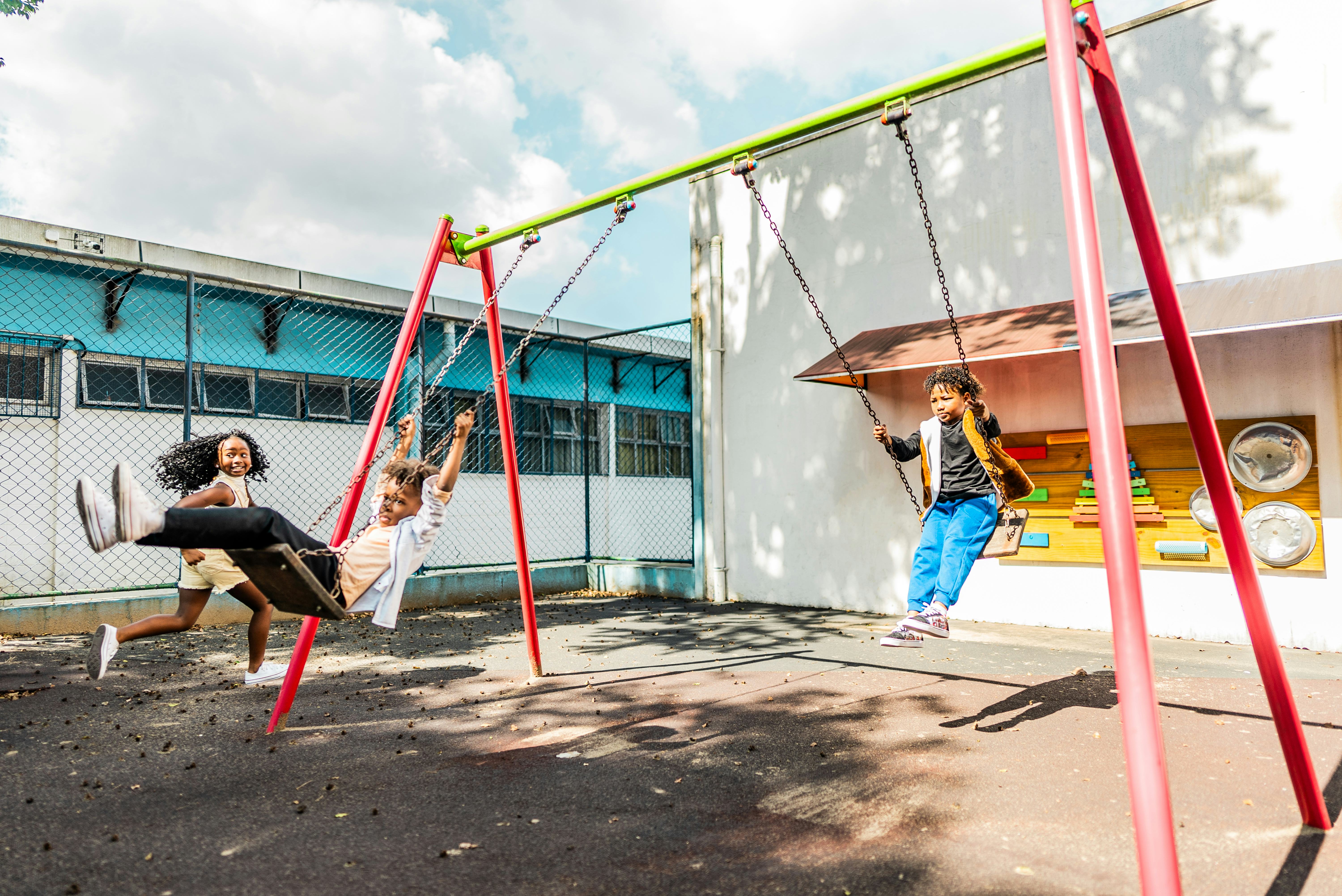 Students playing on swing on school playground