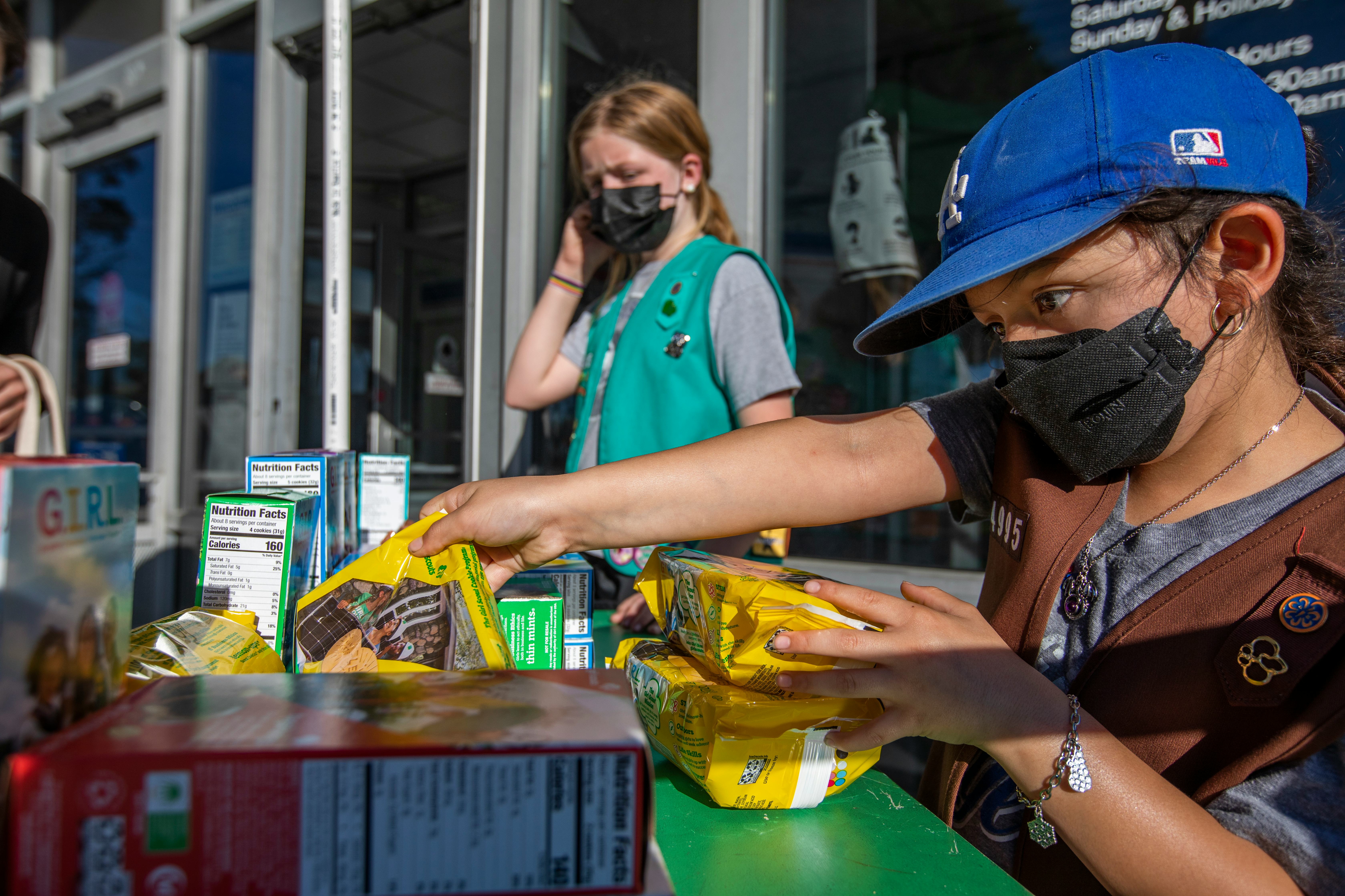 Madar Mee, 10, left, and Emma Diaz, 7, right, are selling Girl Scout Cookies in the Mar Vista neighb...