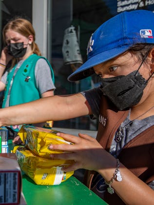Madar Mee, 10, left, and Emma Diaz, 7, right, are selling Girl Scout Cookies in the Mar Vista neighb...
