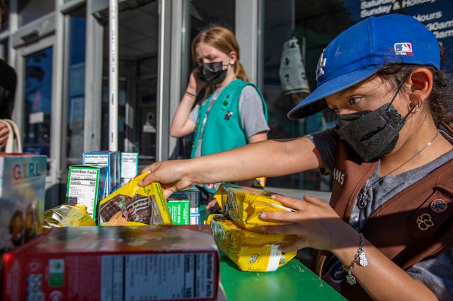Madar Mee, 10, left, and Emma Diaz, 7, right, are selling Girl Scout Cookies in the Mar Vista neighb...