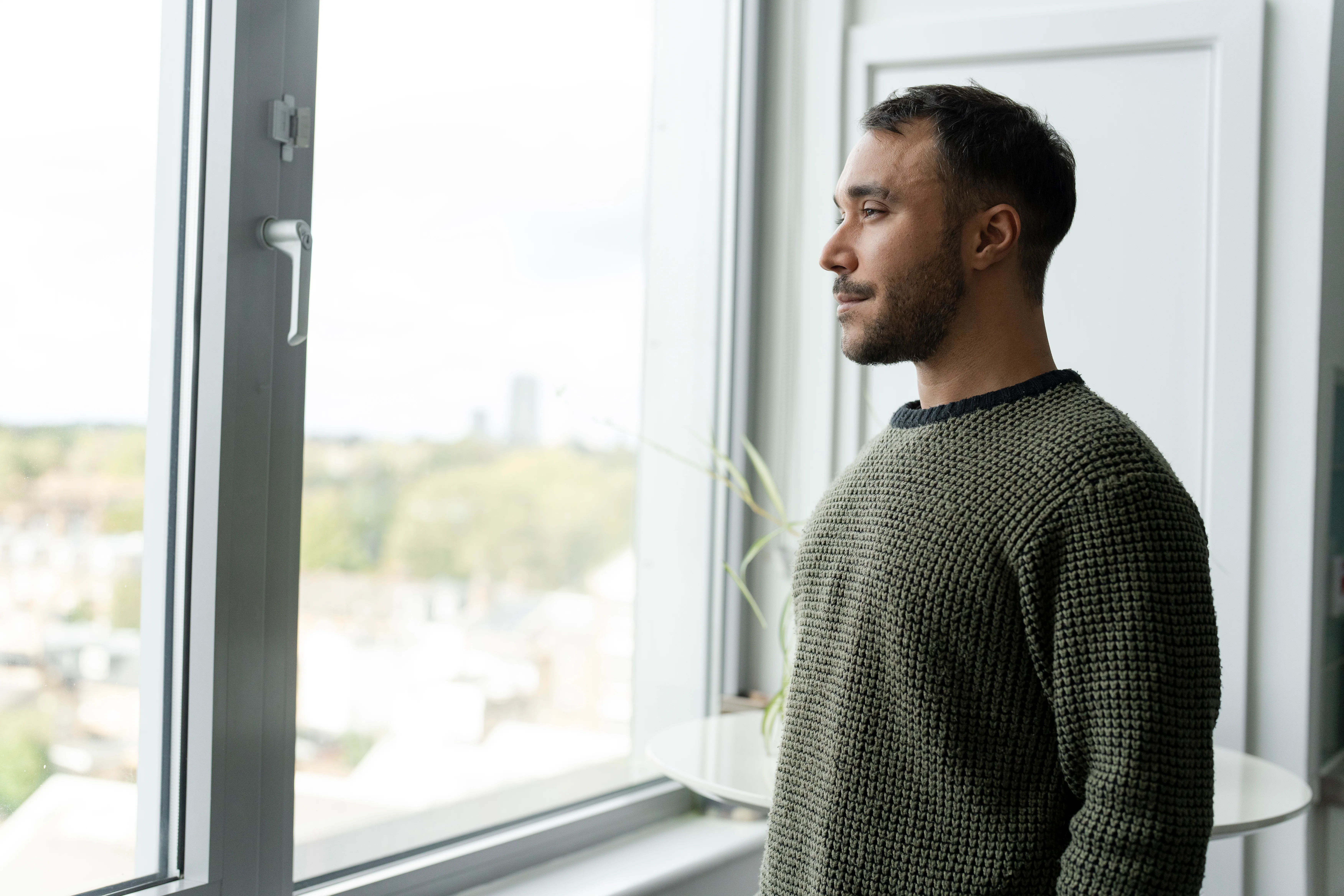 Mature man looking through window