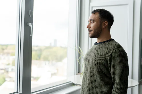 Mature man looking through window