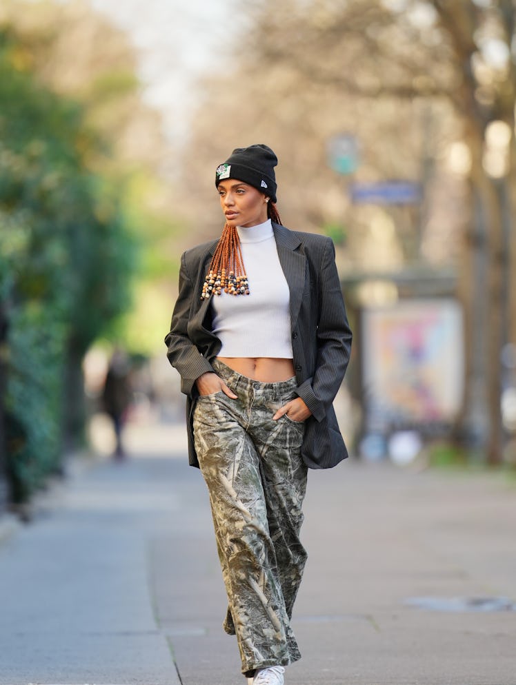 PARIS, FRANCE - DECEMBER 13: Alicia Aylies wears long auburn braids finished with decorative beads, ...