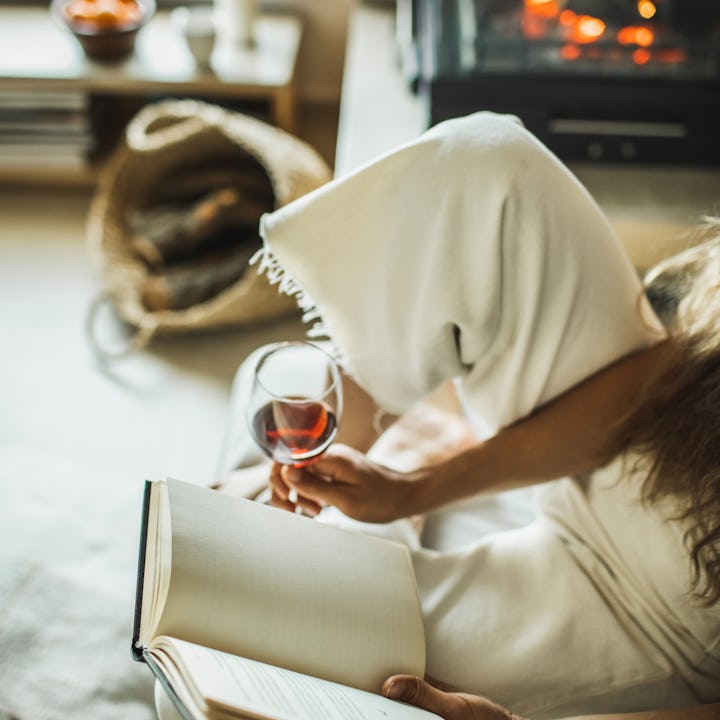 Leisure and relaxation in evening, autumn pleasures. Lady in white clothes sitting and enjoying at f...