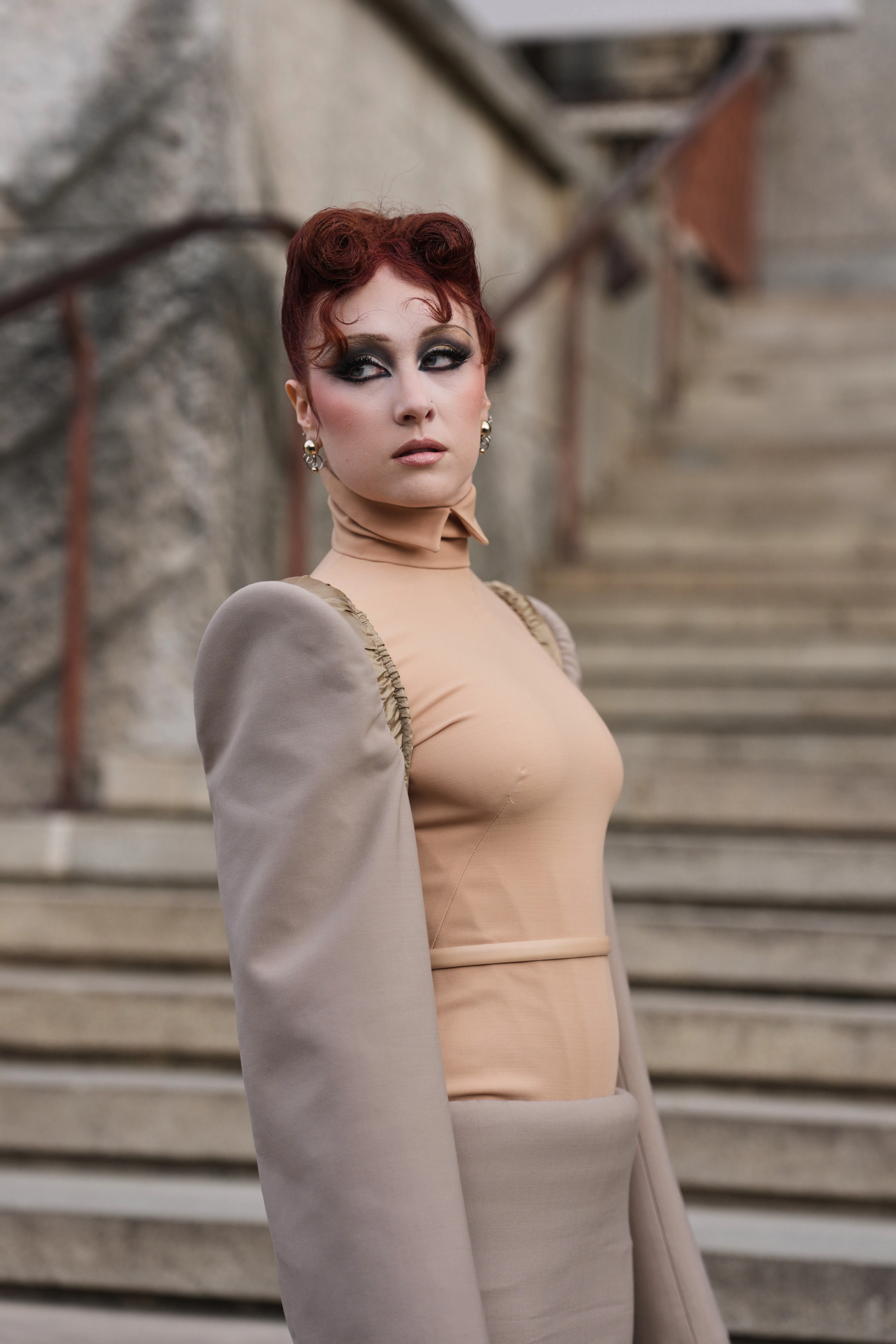 Chappell Roan with a french roll inspired hairstyle on stairs in paris