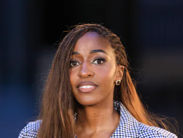 Ayo Edebiri at the Chanel show with her braids worn long and loose