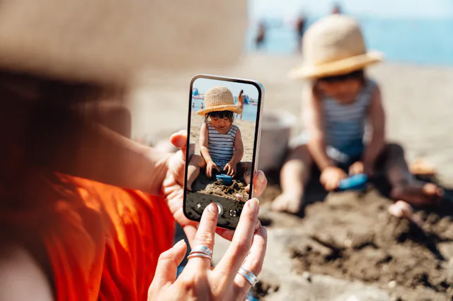 Young Asian mother and daughter having fun on the beach. Summer family vacation. Motherhood and well...