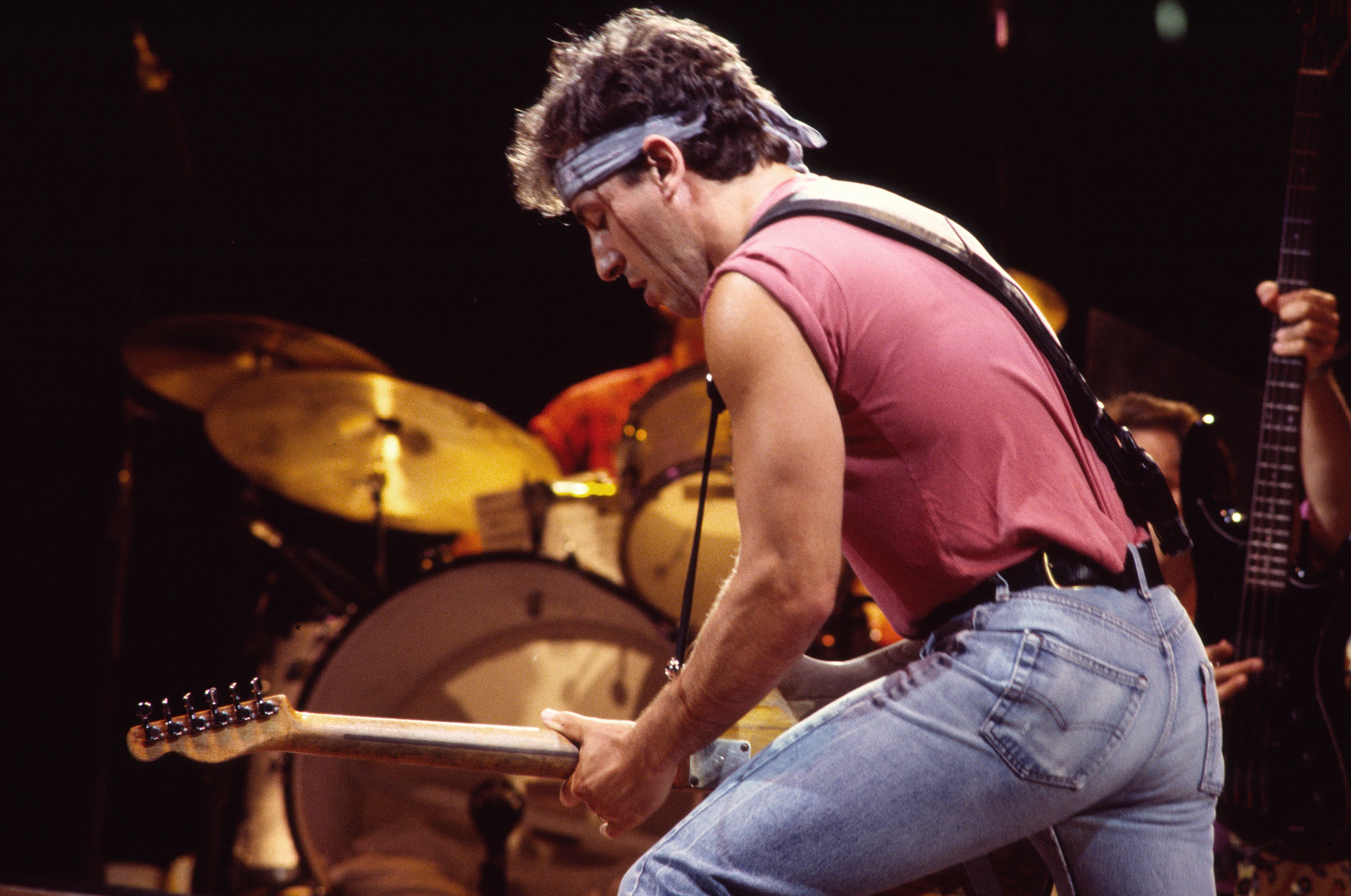 Bruce Springsteen plays guitar as he performs onstage