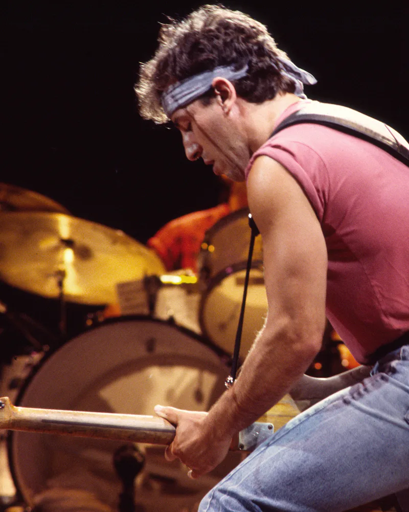 Bruce Springsteen plays guitar as he performs onstage
