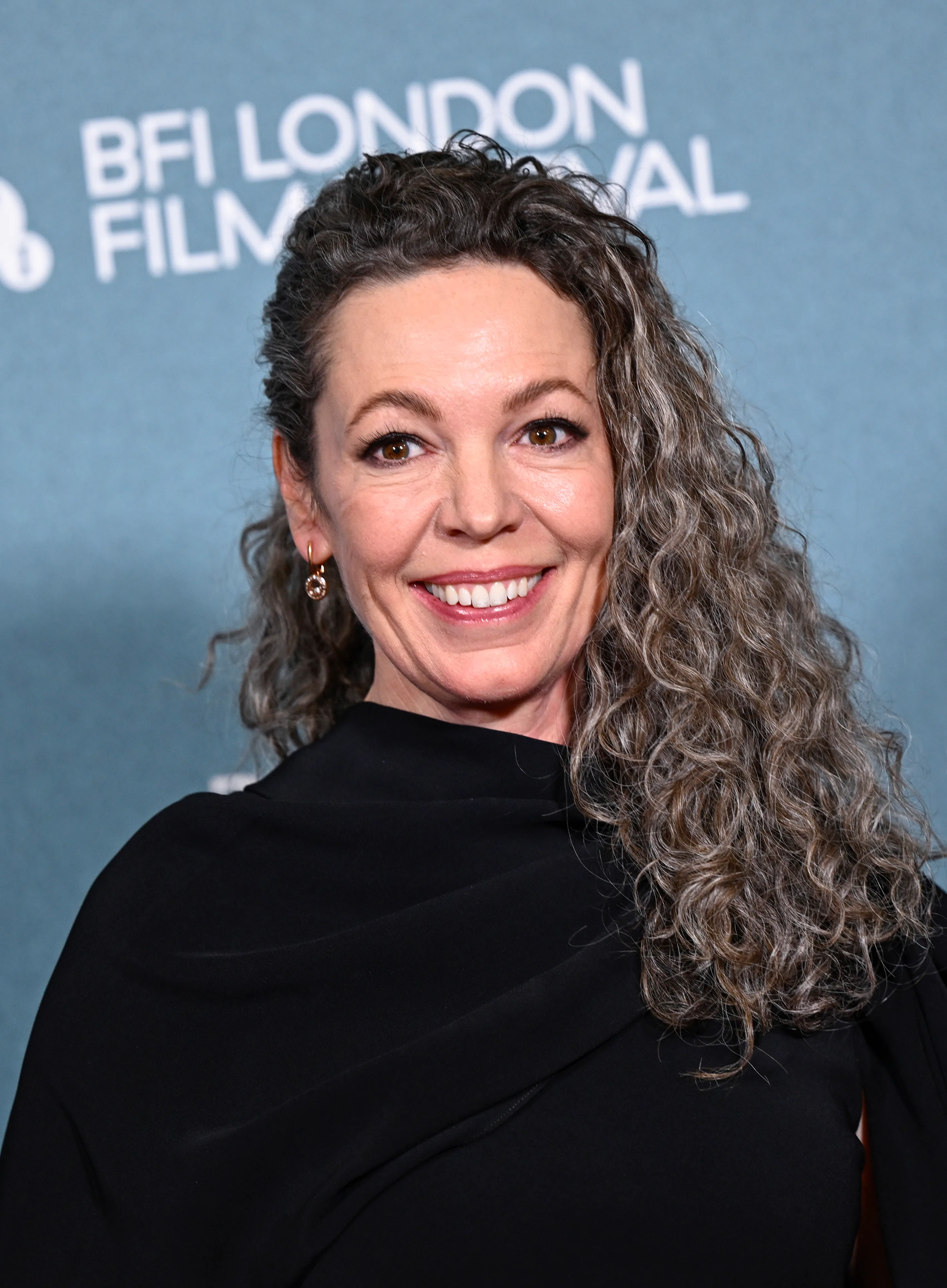Olivia Colman at the London premiere of "Wicker" with curly gray hair
