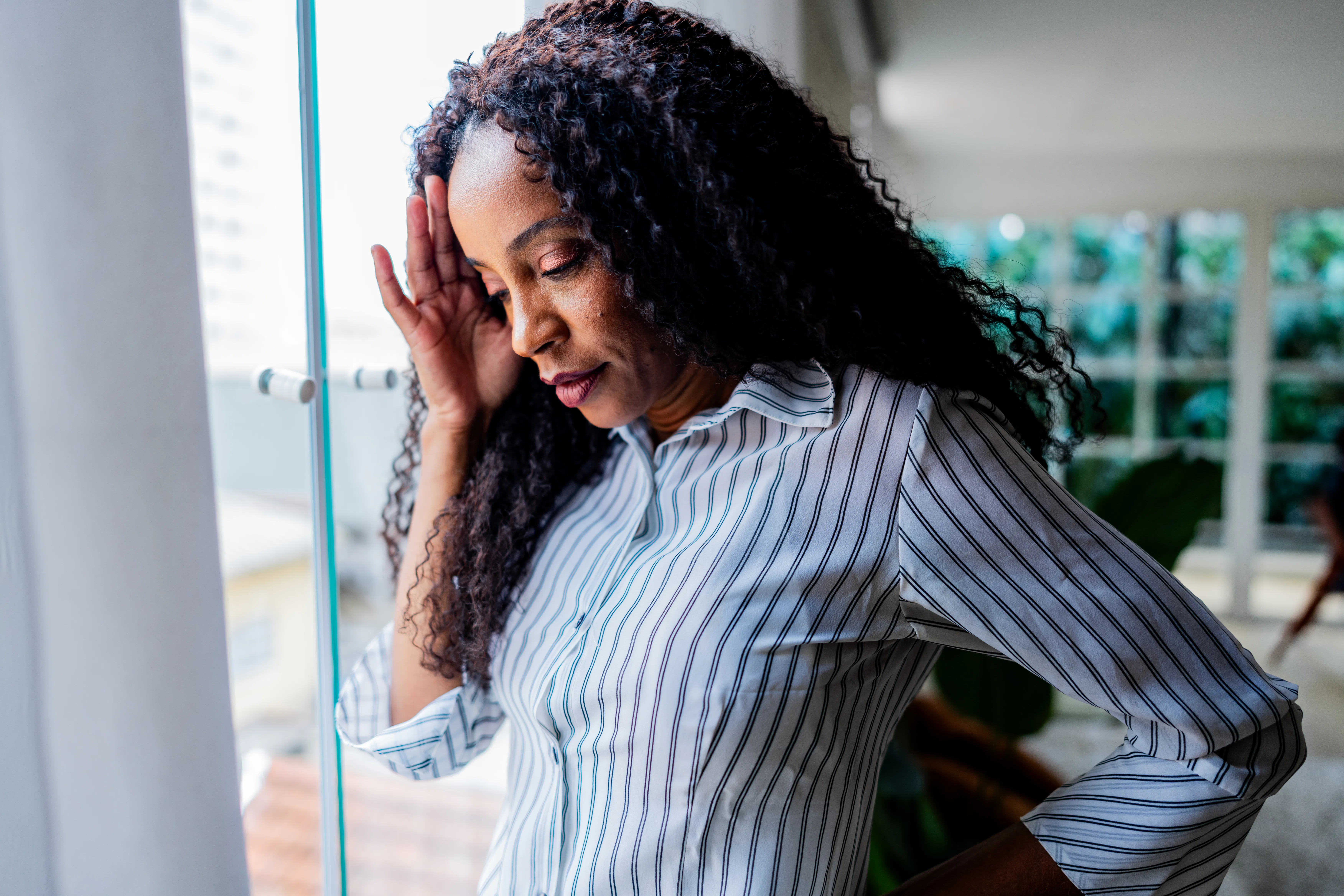 Mature businesswoman with headache on office