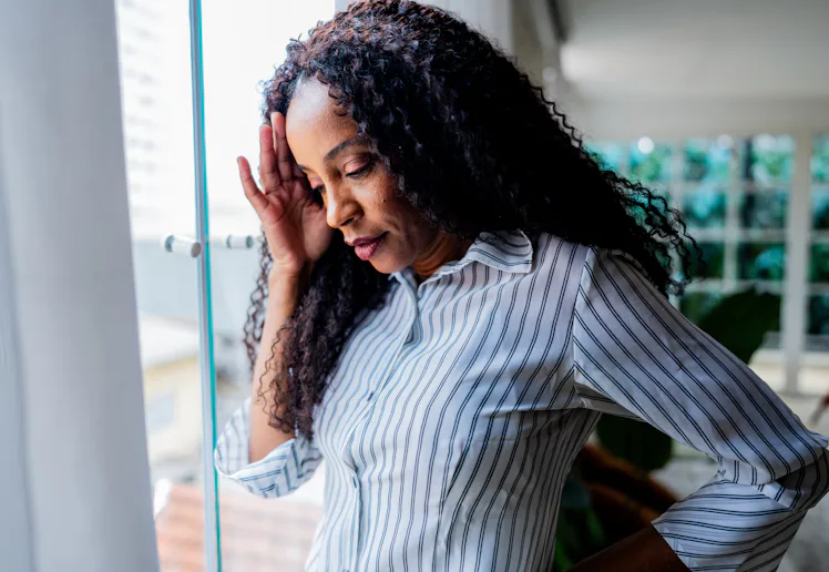 Mature businesswoman with headache on office