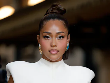 Jordyn Woods attends Vogue World: Milano 2026 in a white gown with sparkly eye makeup