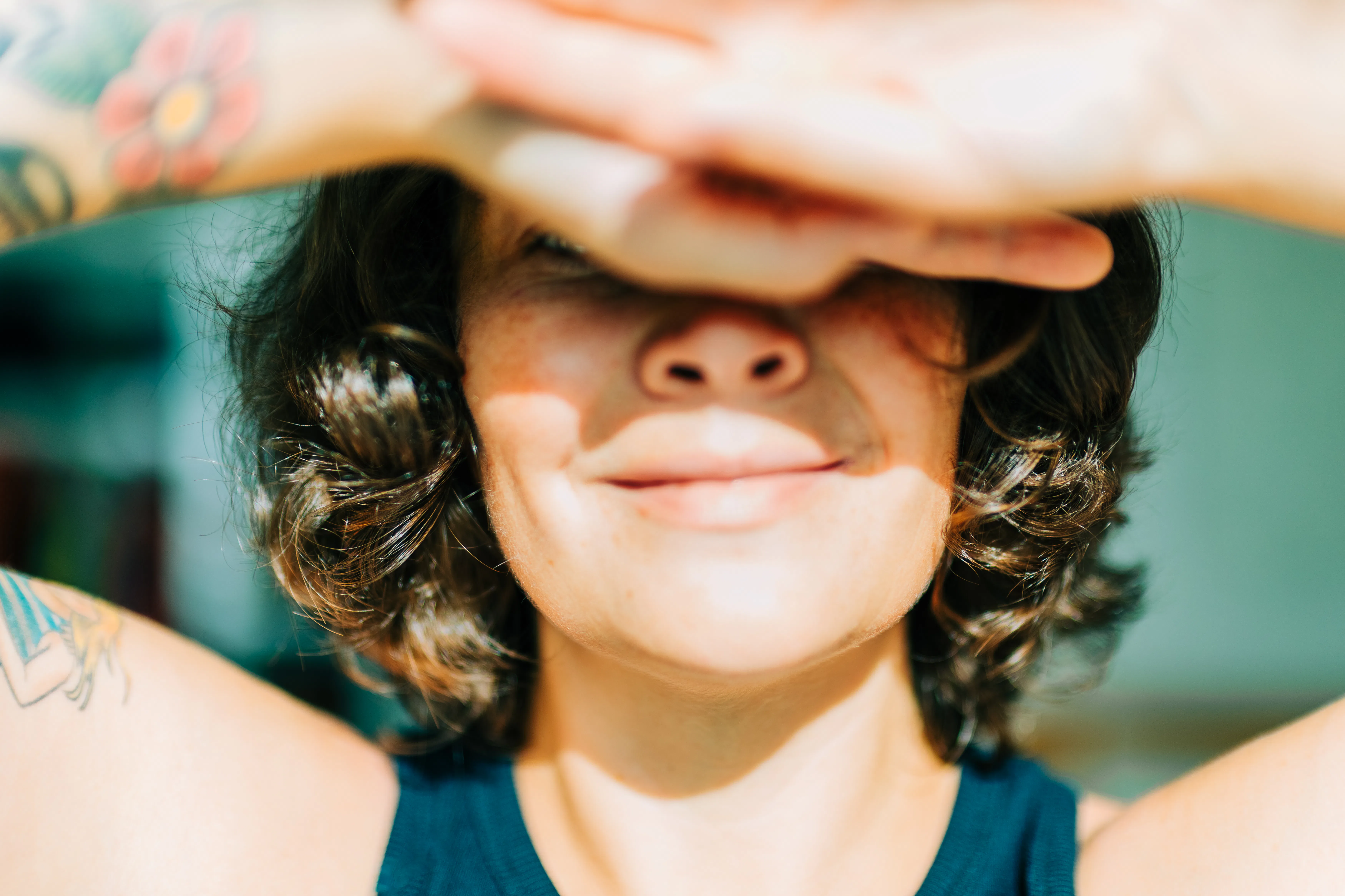 Woman shielding eyes from sun feeling happy
