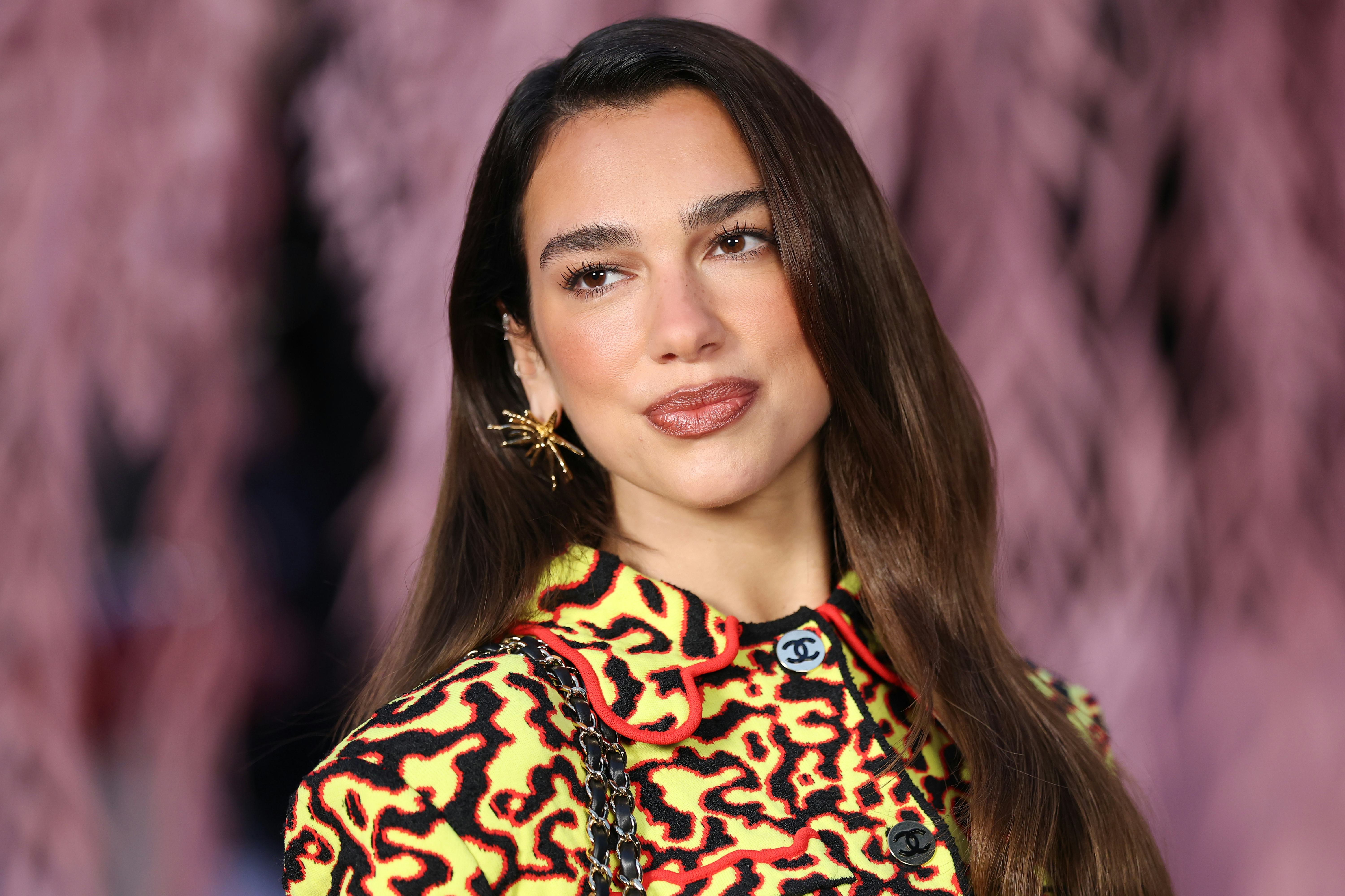 Dua Lipa wore a sheer top and slinky LBD on her latest vacation.