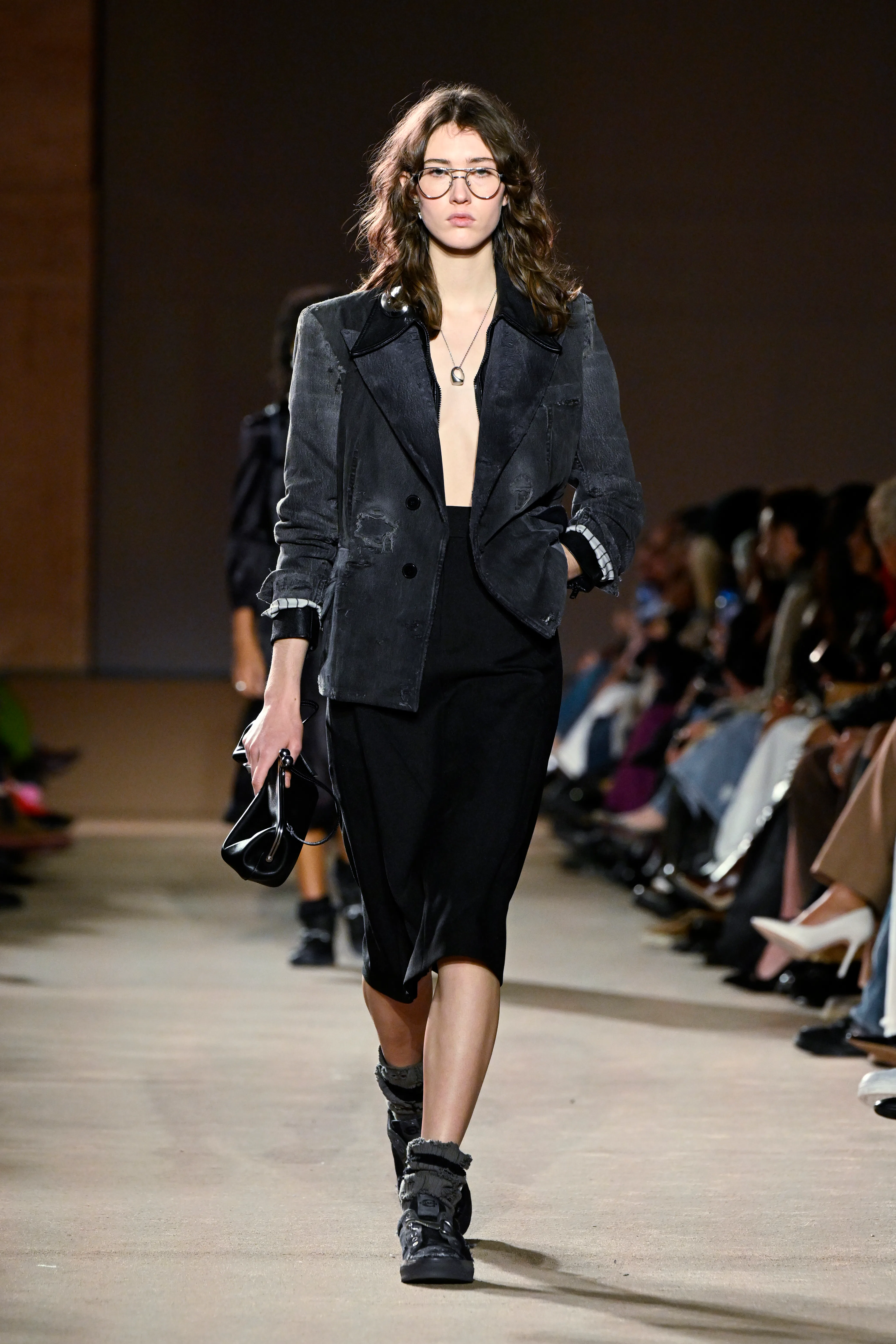 Model on the runway at the Coach fashion show as part of RTW Fall 2026