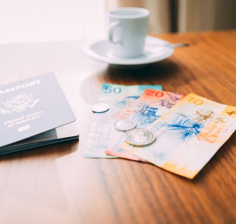Candid shot of Swiss currency Francs on a hotel room table with authentic looking natural window lig...