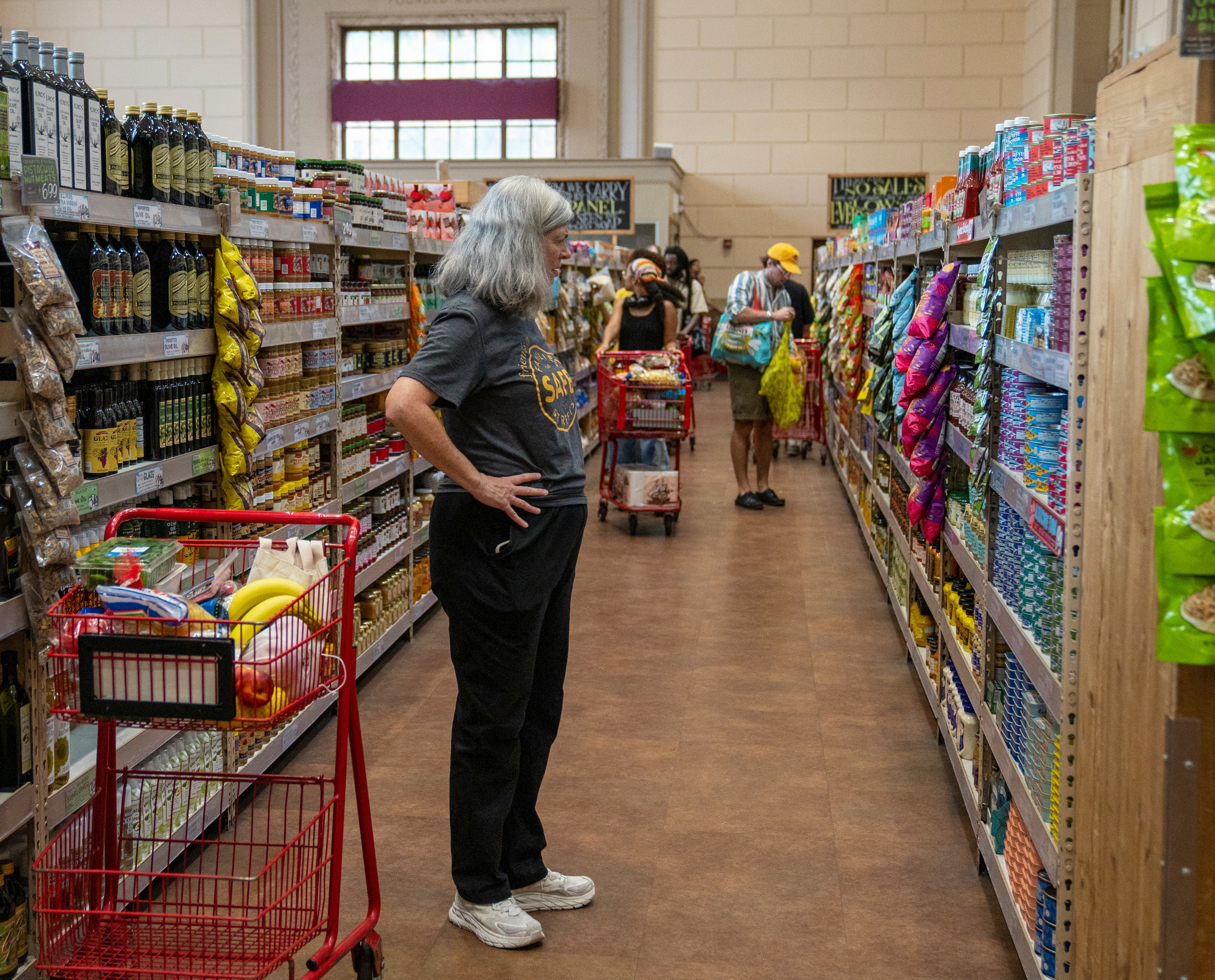 NEW YORK, NEW YORK - AUGUST 31: A shopper views a shelf of canned items August 31, 2024 at a Trader ...