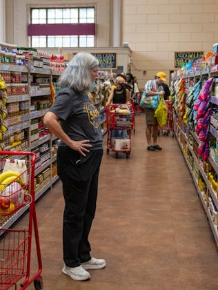 NEW YORK, NEW YORK - AUGUST 31: A shopper views a shelf of canned items August 31, 2024 at a Trader ...