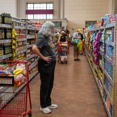 NEW YORK, NEW YORK - AUGUST 31: A shopper views a shelf of canned items August 31, 2024 at a Trader Joe's grocery market in New York City. (Photo by Robert Nickelsberg/Getty Images)