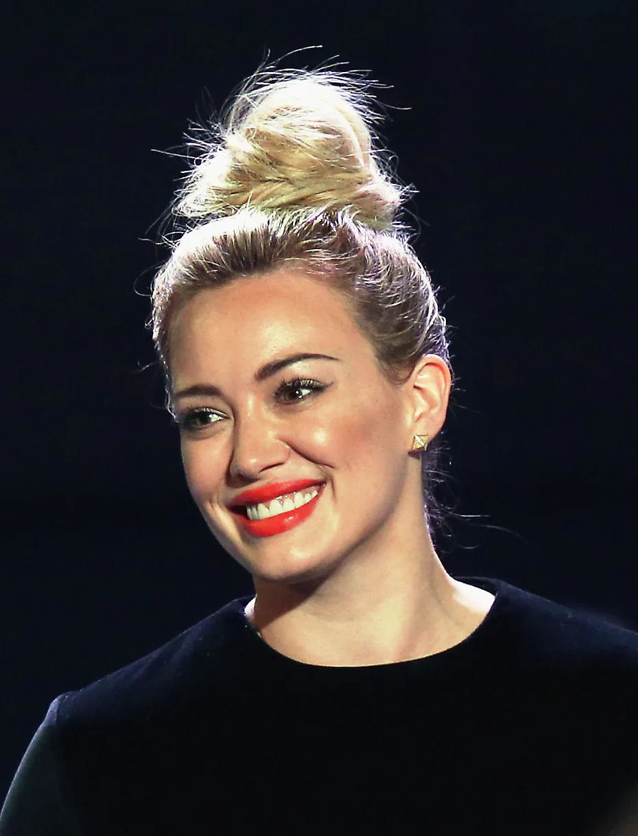 Hilary Duff with a large bun at the top of her head