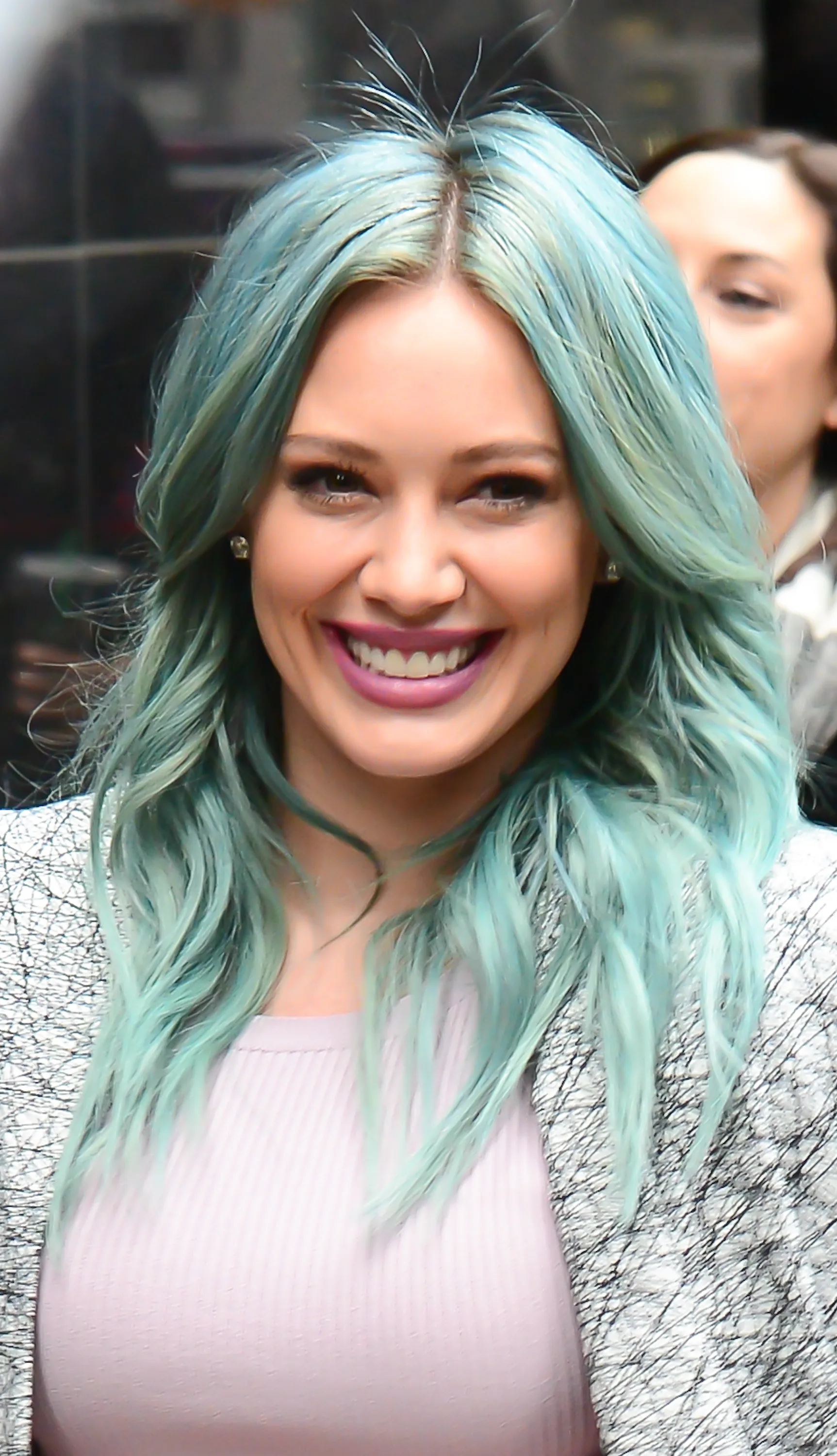Hilary Duff with seafoam green hair and pastel pink lips