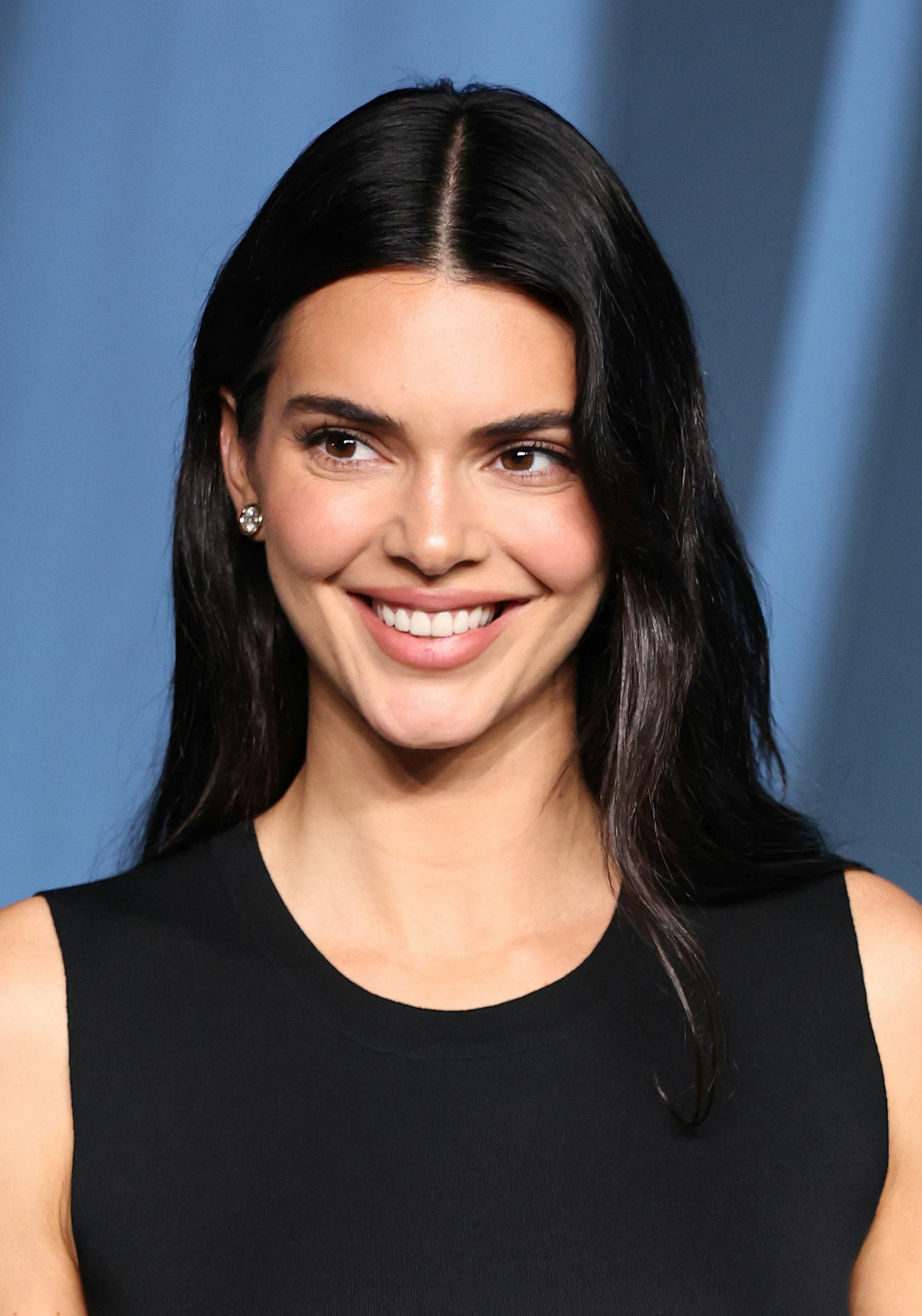 Kendall Jenner’s Super Bowl outfit included a tie-up crop top and jeans.