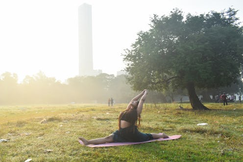 A woman is practicing yoga in a field on a foggy winter morning in Kolkata, India, on December 10, 2...