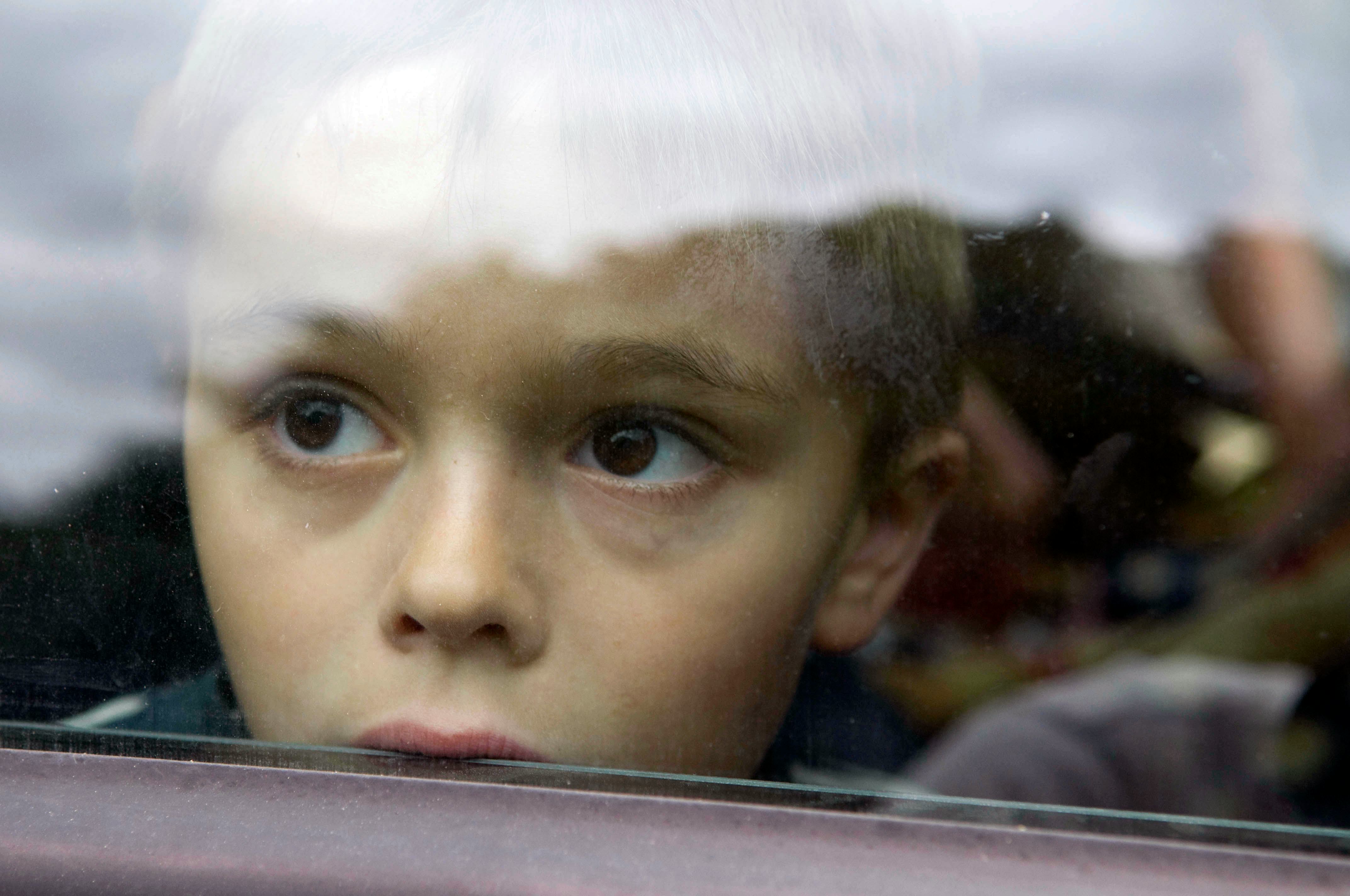 Child with dreamy eyes, his face against a window. (reproduction rights ok). 5-10 years old, 5 to 10...