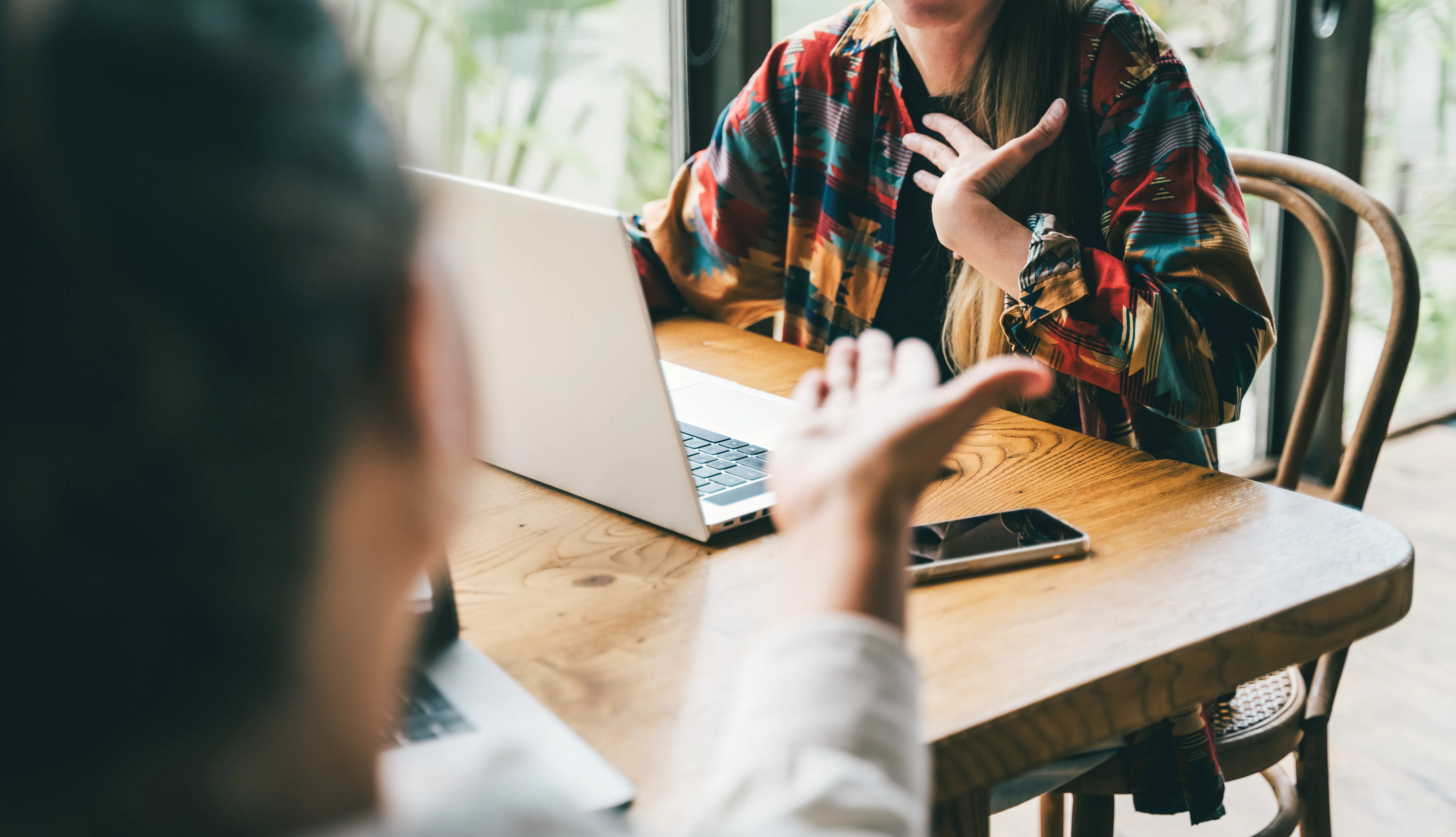 Two colleagues in the middle of a dynamic brainstorm or a lively discussion, an argument, gesturing ...