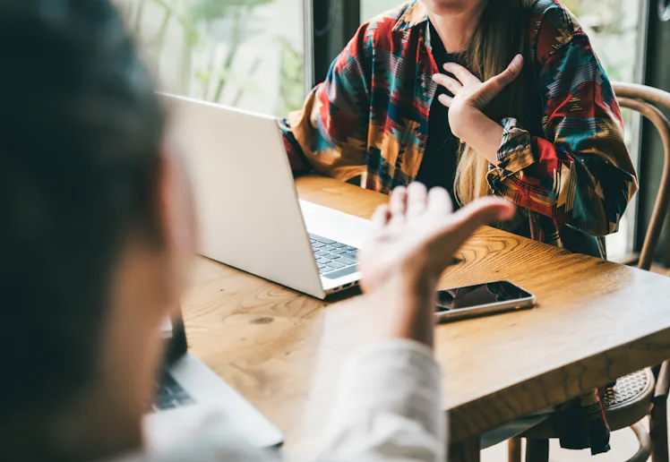 Two colleagues in the middle of a dynamic brainstorm or a lively discussion, an argument, gesturing ...
