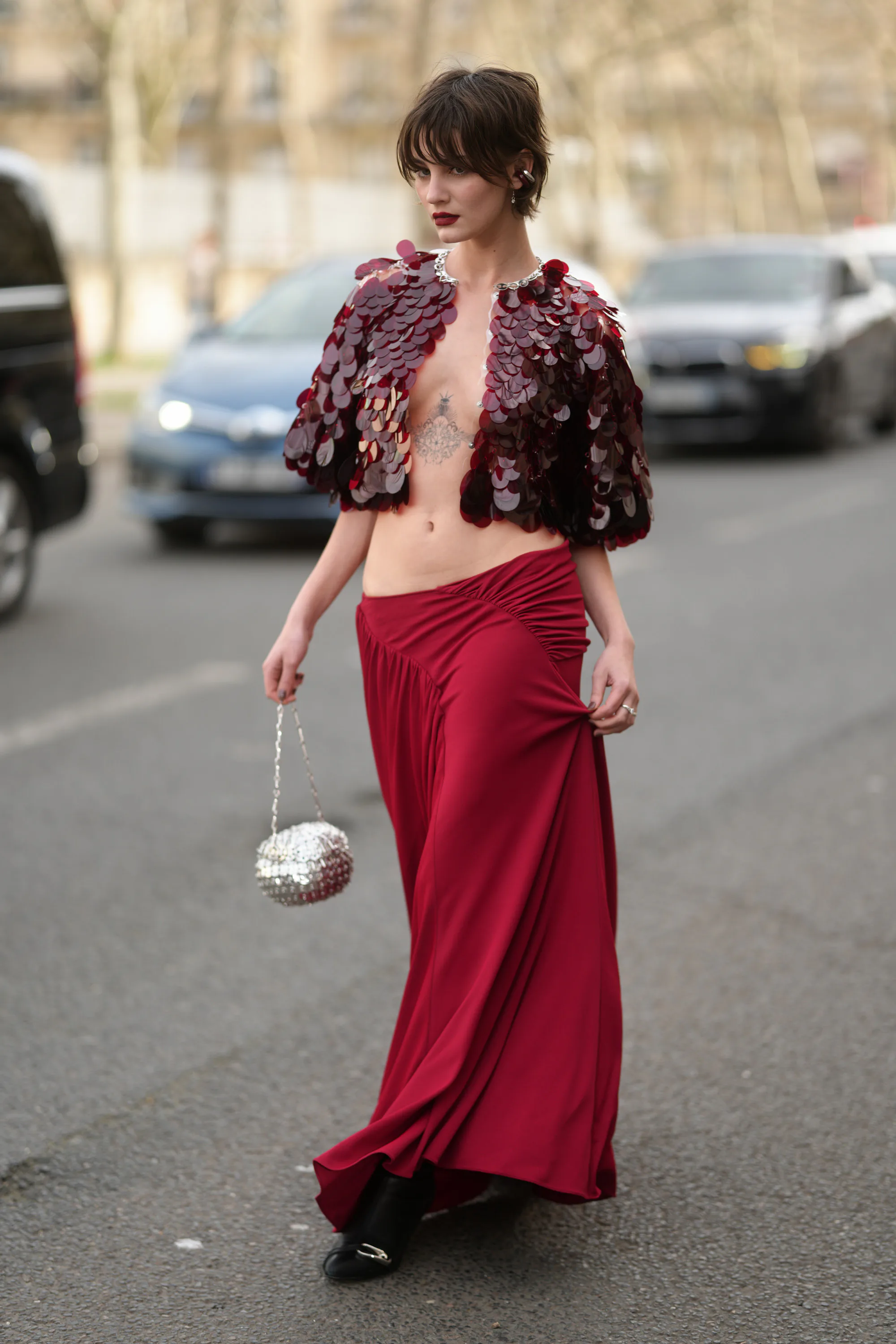PARIS, FRANCE - MARCH 05: Bec Lauder is seen wearing a burgundy sequined capelet with oversized pail...