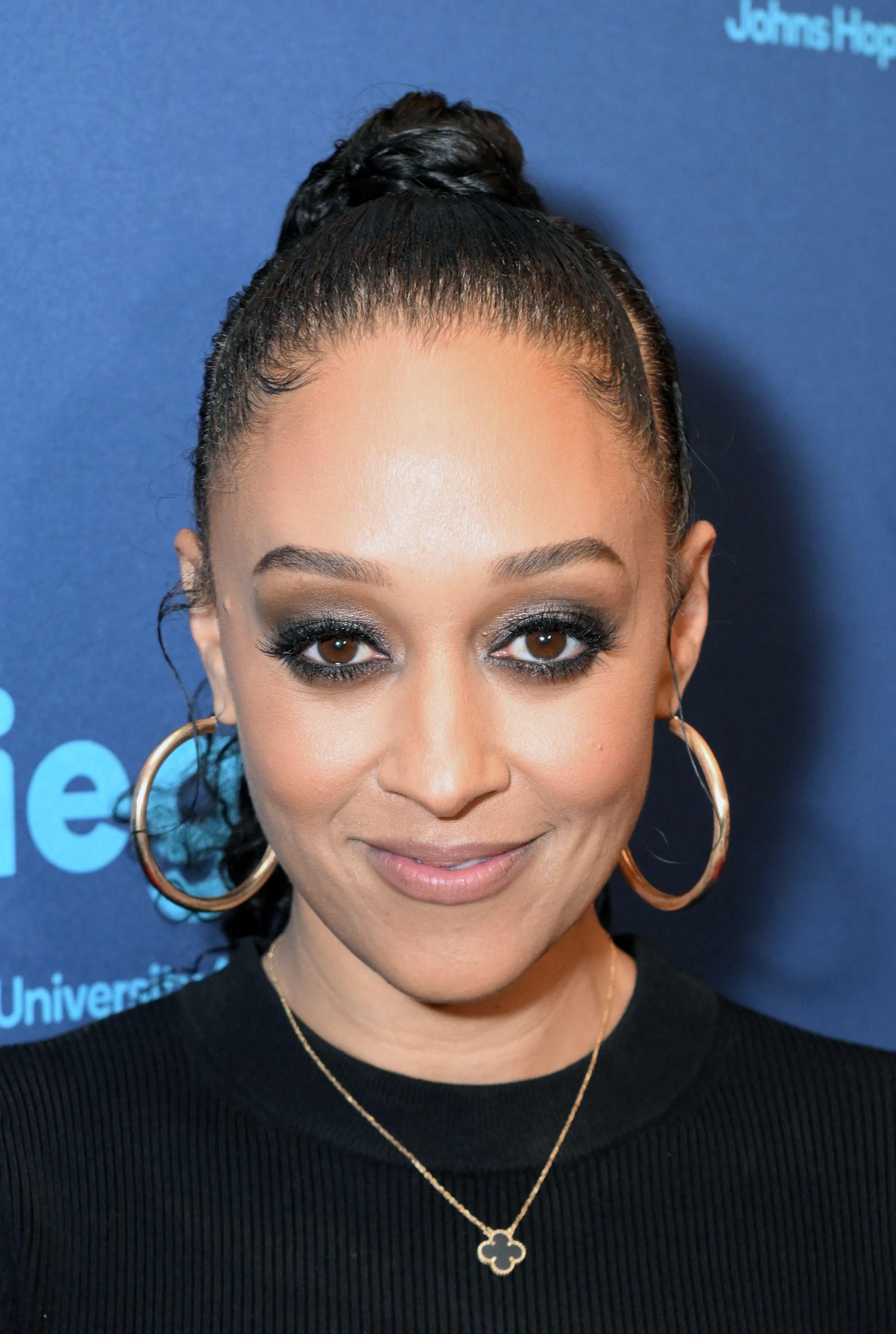 Tia Mowry at a gala with glittery smoky eyes