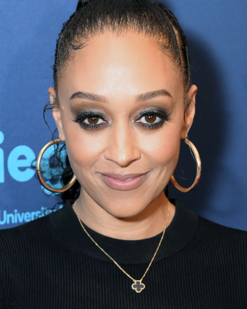 Tia Mowry at a gala with glittery smoky eyes