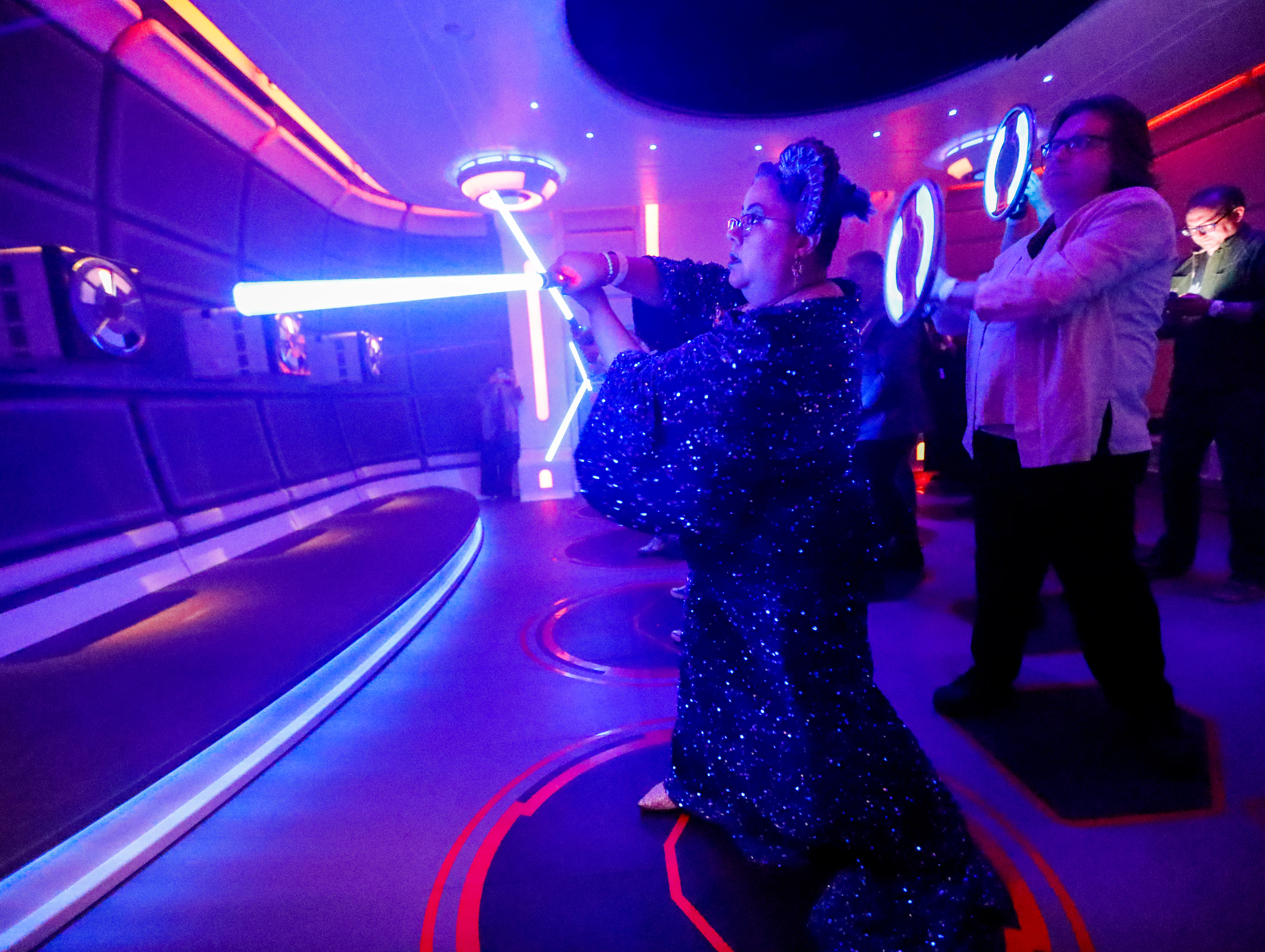 Orlando, Fla - March 01: Rachael Belemjian, of Maryland, dressed as La-Nee character, gets light sab...