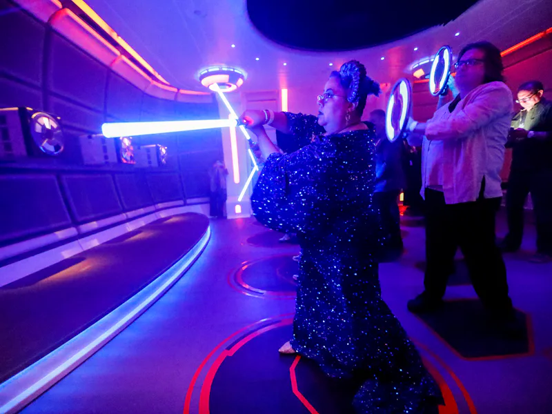 Orlando, Fla - March 01: Rachael Belemjian, of Maryland, dressed as La-Nee character, gets light sab...