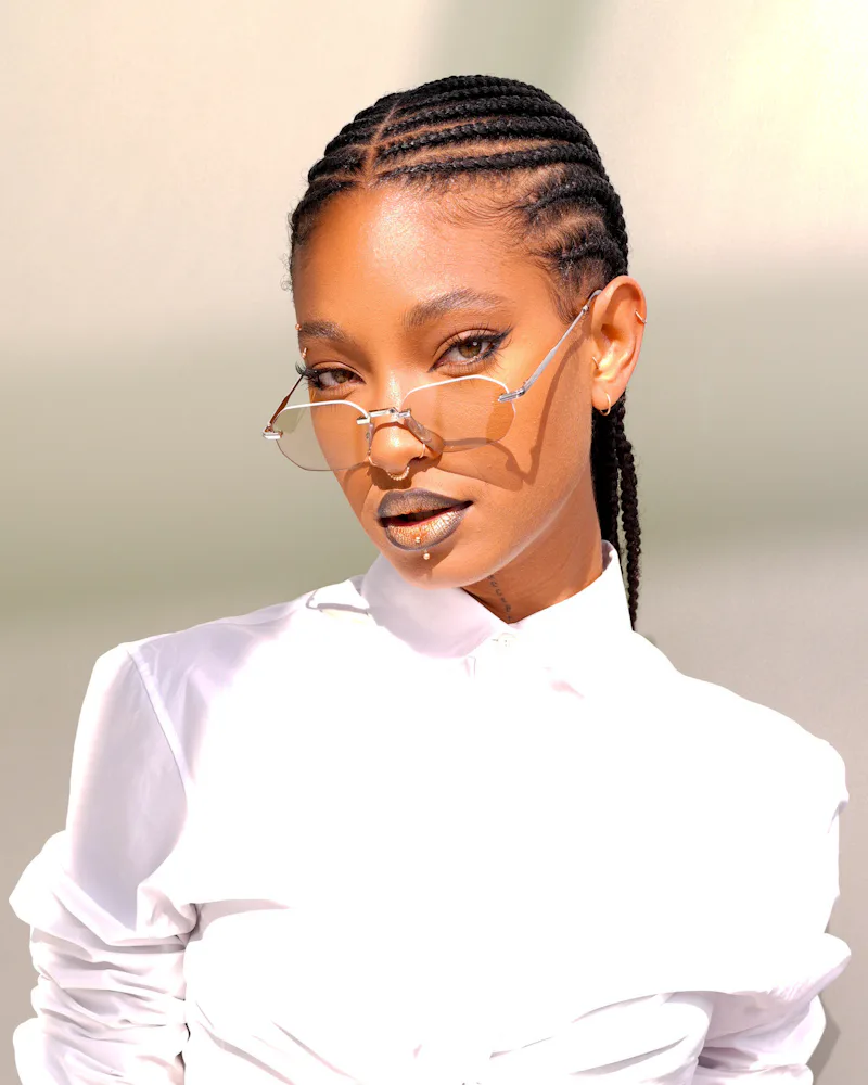 Willow Smith at the Dior fashion show with cool braids and lipstick