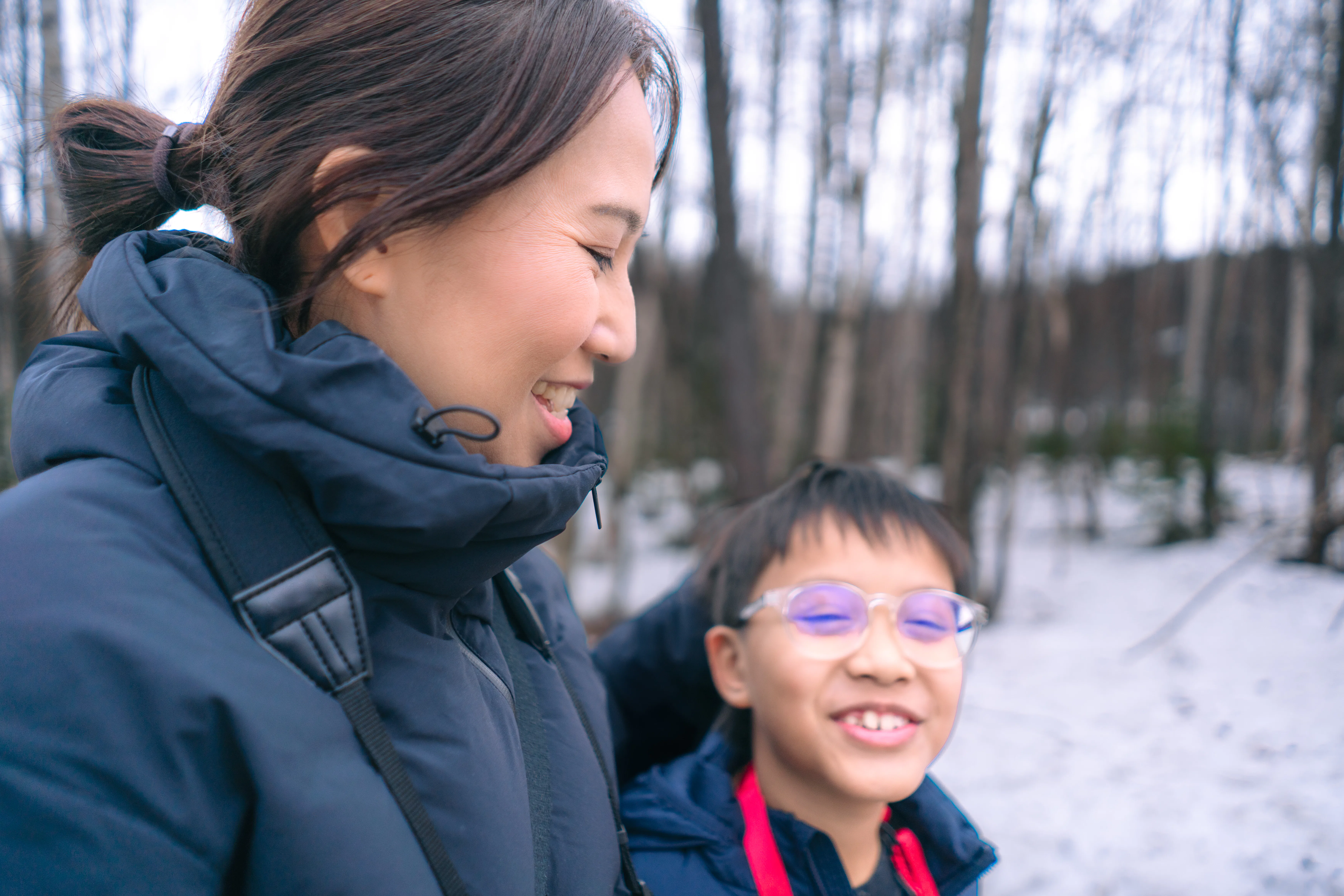A mom and her son take a winter walk. 