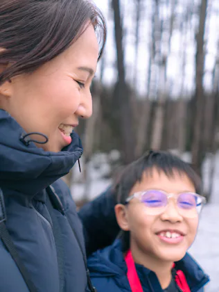 A mom and her son take a winter walk.