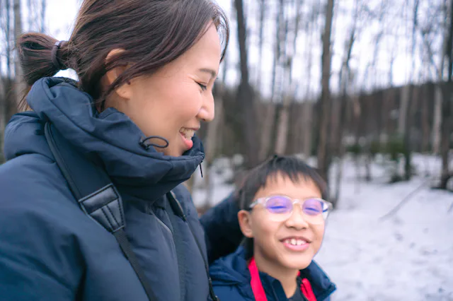 A mom and her son take a winter walk.