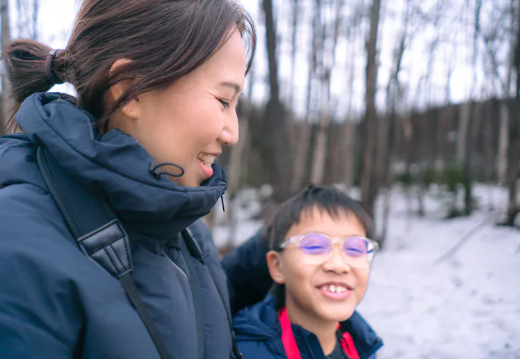 A mom and her son take a winter walk.